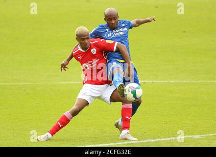 Barnsley's Elliot Simoes (left) and Nottingham Forest's Fouad Bachiron battle for the ball during the Carabao Cup first round match at Oakwell Stadium, Barnsley. Stock Photo