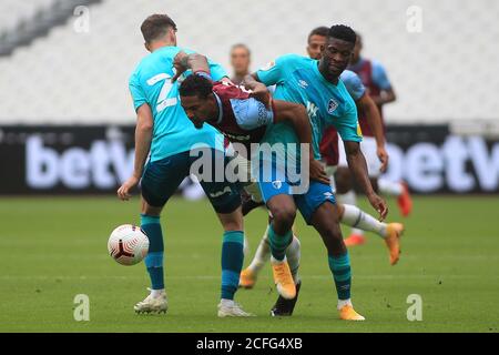 Sebastien Haller of West Ham United (M) is fouled by Jack Simpson (L) and Jefferson Lerma of Bournemouth (R). Pre-season friendly match, West Ham United v AFC Bournemouth at the London Stadium, Queen Elizabeth Olympic Park in London on Saturday 5th September 2020. this image may only be used for Editorial purposes. Editorial use only, license required for commercial use. No use in betting, games or a single club/league/player publications . pic by Steffan Bowen/Andrew Orchard sports photography/Alamy Live news Stock Photo