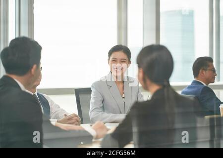 young asian business woman laughing during team meeting in office Stock Photo