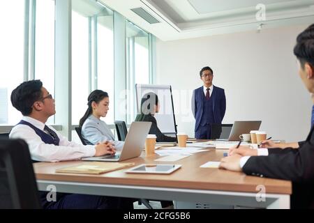 asian boss delivering a speech during meeting in company conference room Stock Photo