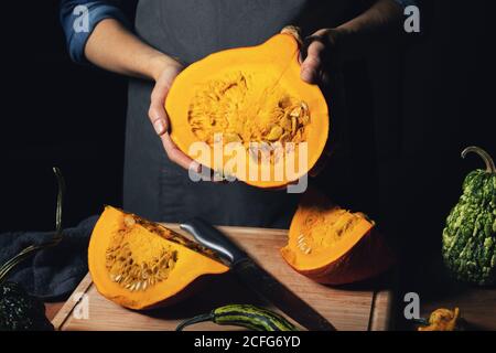 autumn harvest - woman holding pumpkin in hands. cross section Stock Photo