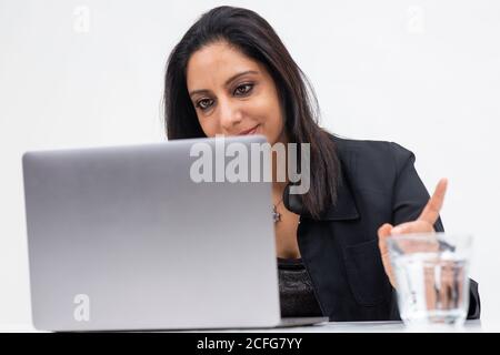 Portrait of professional Indian businesswoman working from her computer, Freelancer, work from home, Smiling corporate lady. Stock Photo