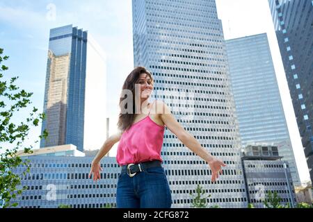 Determined smiling businessWoman against skyscrapers in downtown Stock Photo