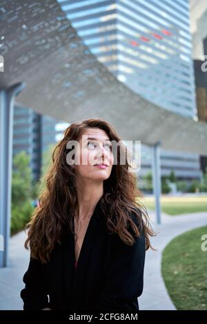 Determined smiling businessWoman against skyscrapers in downtown Stock Photo
