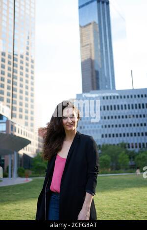 Determined smiling businessWoman against skyscrapers in downtown Stock Photo