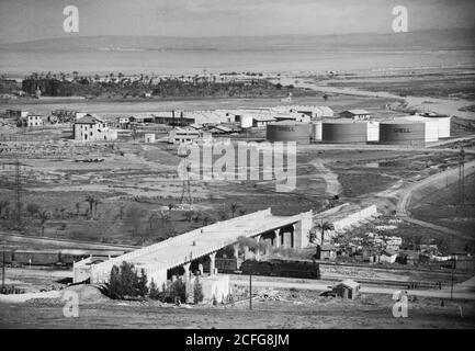 "Original Caption:  ""Shell"" oil tanks near Haifa showing bridge across R.R. [i.e. railroad]  - Location: Israel--Haifa ca.  1934-1939 " Stock Photo