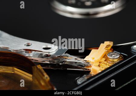 Disassembled laptop hard disk drive, hdd. Close-up. Opened hard drive, magnetic heads and disk plates. Stock Photo