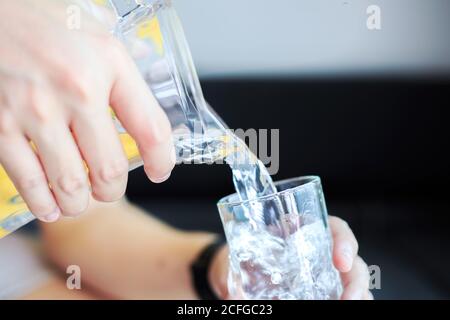 hand hold jar and pour water. Stock Photo