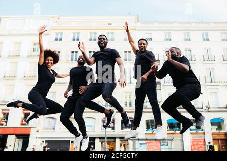 Black cool people jumping in the street and looking at camera Stock Photo