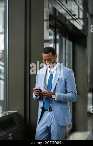 Trendy black businessman using phone Stock Photo