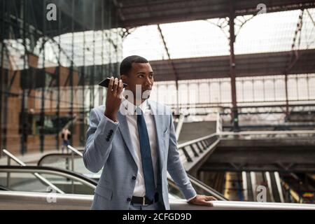 Trendy black businessman using phone Stock Photo