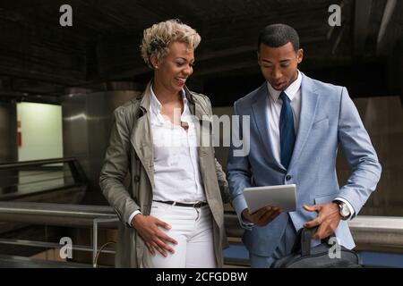 Cheerful elegant African-American man and Woman watching tablet together and smiling. Stock Photo