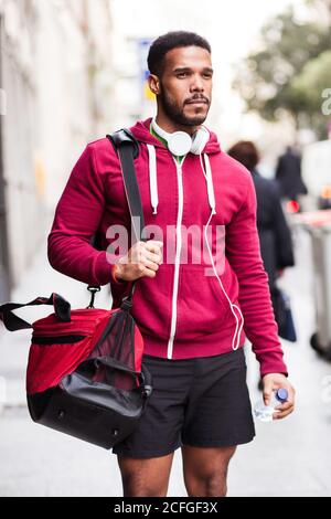 Young man walking around the city wearing sportswear Stock Photo