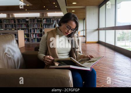 Pretty Woman in glasses reading a book Stock Photo