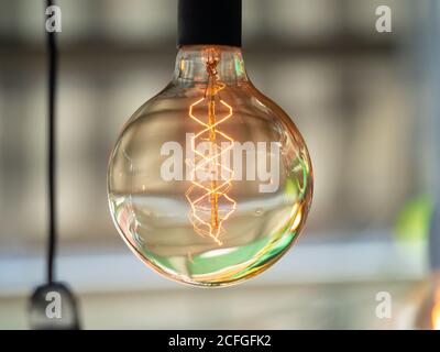 Edison vintage decorative light bulb with LED filament diffuses soft, restful light in the room Stock Photo