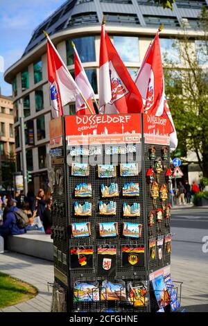 Colourful postcard stand, displaying Düsseldorf souvenirs and postcards in front of a newsstand in downtown Düsseldorf. Stock Photo