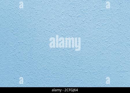Light blue wall of the building. Rough plaster surface. Abstract background. Stock Photo