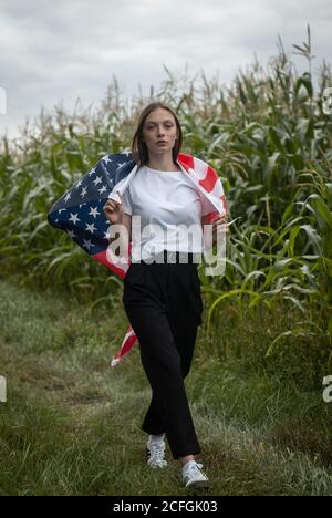 a young American woman with the stars and stripes, Stock Photo