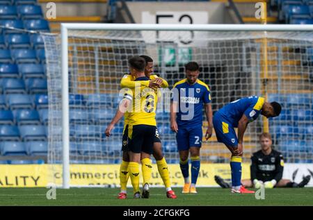 Oxford, UK. 05th Sep, 2020. Marcus McGuane (on loan from Nottingham Forest) of Oxford United embraces goalscorer Cameron Brannagan of Oxford United during the Carabao Cup first round match between Oxford United and AFC Wimbledon played behind closed doors due to the current government covid-19 guidelines instructing matches to be played without supporters at the Kassam Stadium, Oxford, England on 5 September 2020. Photo by Andy Rowland/PRiME Media Images. Credit: PRiME Media Images/Alamy Live News Stock Photo