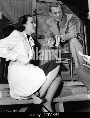 DOLORES DEL RIO and JOSEPH COTTEN on set candid during filming of JOURNEY INTO FEAR 1943 director NORMAN FOSTER and  ORSON WELLES novel Eric Ambler screenplay Orson Welles and Joseph Cotten producer Orson Welles RKO Radio Pictures Stock Photo