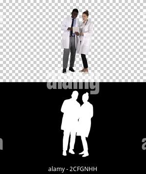 Intellectual healthcare professional afro american doctor with collegue using digital tablet, Alpha Channel Stock Photo