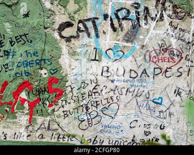 Detail of a Ruin Bar wall: A portion of the wall in the famous Szimpla Ruin Bar covered in graffiti as patrons try to leave their mark o the thick plaster and green paint of the walls. Stock Photo