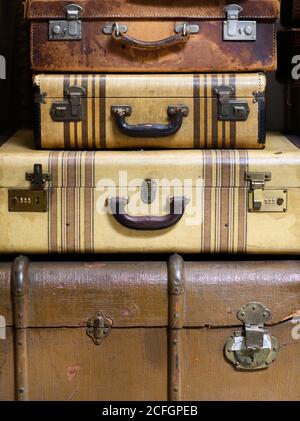 Vintage suitcases and trunk stacked together on top of each other in a close up cropped view conceptual of travel Stock Photo