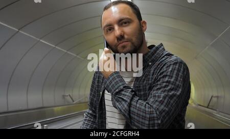 Cheerful man calling to friend. Stock Photo