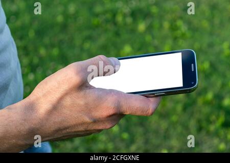 man hand holding black mobile phone with white screen Stock Photo