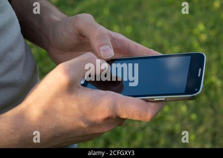 man both hands on mobile phone Stock Photo