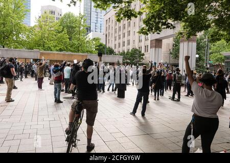 Seattle, USA - May 31, 2020: BLM protestors in Westlake park late in the day. Stock Photo