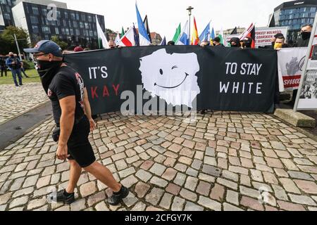 Gdansk, Poland. 5th Sep, 2020. The 'No more brother war' march participant wearing the European Brotherhood support 52 t-shirt standing in front of banner that speaks Its OK to stay white and smiled map of Poland is seen in Gdansk, Poland, on 5 September 2020 The march of the far-right, nationalist and racist organizations passed through the streets of the Gdansk city with a strong police escort. March participants chanted nationalist slogans as White Europe, White Life Matters, Scrap the Eu! etc. Credit: Vadim Pacajev/Alamy Live News Stock Photo