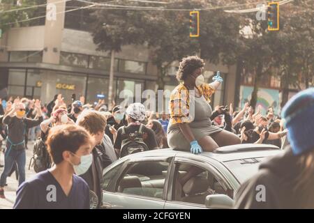 Seattle, USA - May 31, 2020: BLM protestors in Westlake park late in the day. Stock Photo