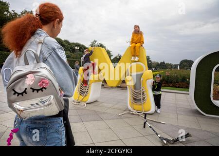 Moscow, Russia. 5th of September, 2020 People take photos against the background of a funny installation of the letters of the word Moscow at the main entrance to Gorky Park during the celebration of the Moscow's City Day. Russia Stock Photo