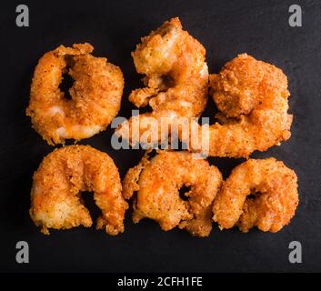 Shrimps in batter on black stone background Stock Photo