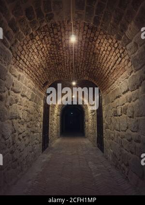 Old wine cellar tunnel at the Hincesti winery underground of the Manuc Bei mansion in Moldova. Traditional moldavian rural subterrane stone vault reco Stock Photo