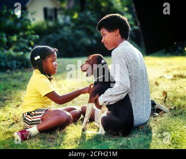 1970s 1980s SERIOUS AFRICAN-AMERICAN MOTHER TEACHING INSTRUCTING DAUGHTER ABOUT CARING FOR PET HOUND DOG WHILE SITTING IN YARD - kj8197 PHT001 HARS OLD TIME NOSTALGIA OLD FASHION 1 JUVENILE YARD STYLE FEAR SAFETY TEAMWORK FAMILIES JOY LIFESTYLE PARENTING FEMALES HEALTHINESS HOME LIFE COPY SPACE FULL-LENGTH LADIES DAUGHTERS PERSONS INSPIRATION CARING PETS SERENITY CONFIDENCE SUMMERTIME HAPPINESS MAMMALS WELLNESS STRENGTH AFRICAN-AMERICANS AFRICAN-AMERICAN AND CANINES EXCITEMENT HOUND BLACK ETHNICITY PRIDE OPPORTUNITY AUTHORITY POOCH CONNECTION CONCEPTUAL CURIOUS INTRODUCING CANINE GROWTH Stock Photo