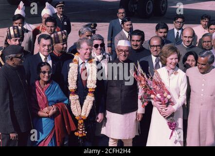 Officials of India welcome Jimmy Carter and Rosalynn Carter during an arrival ceremony in New Delhi India ca.  1 January 1978 Stock Photo