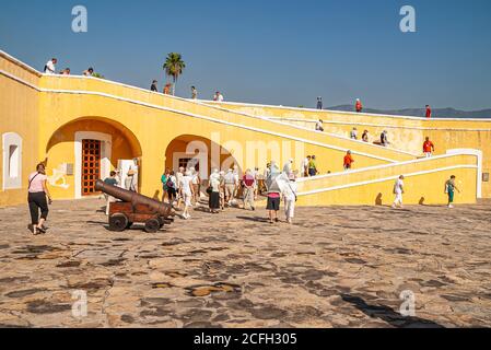 Acapulco, Mexico - November 25, 2008: Central square with cannon on top of Fort, Fuerte de San Diego, AKA Museo Historico shows lots of vistors, yello Stock Photo