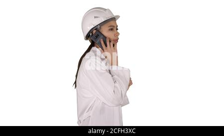 Female science engineer making a call while walking on white background. Stock Photo