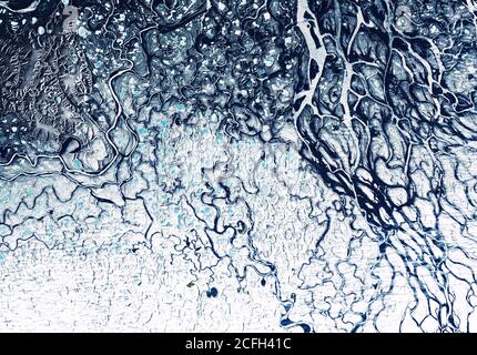 Earth from space, delta of Lena River, Siberia, Russia. Aerial view of winter landscape, abstract texture background. Pattern of frozen terrain on sat Stock Photo