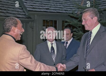 Anwar Sadat greets Ezer Weizman as Menachem Begin looks on ca.  09/07/1978 Stock Photo