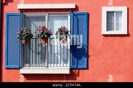 flower pots on outside of a cheerful building Stock Photo