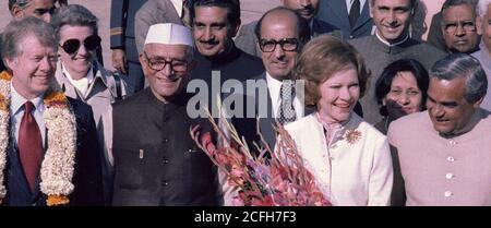 Officials of India welcome Jimmy Carter and Rosalynn Carter during an arrival ceremony in New Delhi India ca.  1 January 1978 Stock Photo