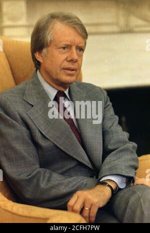 Jimmy Carter seated in the Oval Office ca.  15 August 1977 Stock Photo