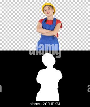 Smiling constructor worker woman standing and changing poses Fold hands, hands on hips, hands in pockets, Alpha Channel Stock Photo