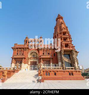 Low angle view of front facade of Baron Empain Palace, a historic mansion inspired by the Cambodian Hindu temple of Angkor Wat, located in Heliopolis district, Cairo, Egypt