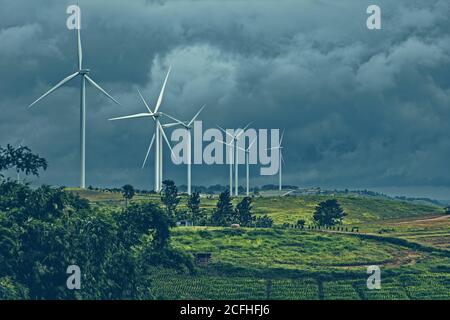 wind turbine on mountain and rain cloud. Stock Photo