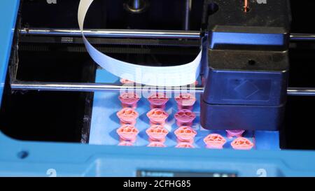 3D printer printing objects from plastic. Stock Photo