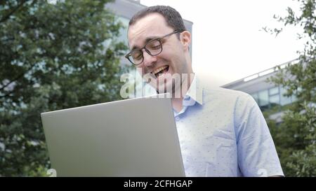 Comic emotion. Nerd business man with crazy smile working with h Stock Photo